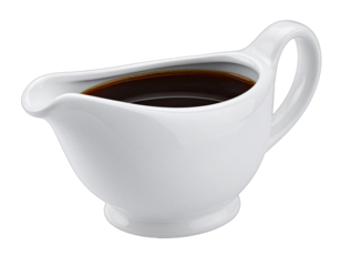 A gleaming white ceramic gravy boat filled with brown liquid, isolated against a dark backdrop