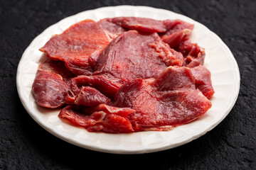Raw Beef Meat Slices on White Plate, Top View