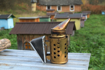 Beekeeping smoker tool on apiary, close-up