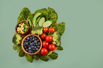 Assortment of fresh organic produce on a green background