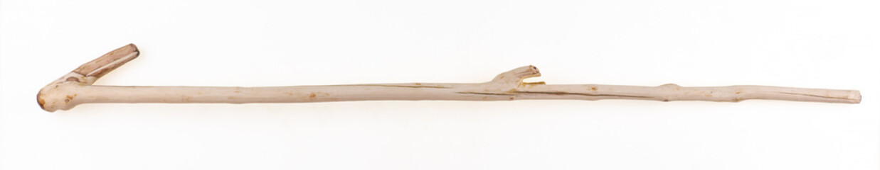 Old wooden shepherd's walking stick isolated on white background