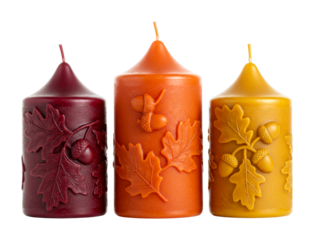 Three decorative autumn candles stand upright, beautifully embossed with intricate oak leaf and acorn designs, perfect for seasonal home decor.