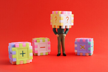 Cube with question marks on the head of an executive and surrounded by others with addition, subtraction and multiplication signs