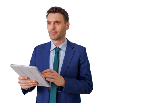Businessman in blue suit holding digital tablet and looking away, communicating, planning, and managing business development - Powered by Adobe