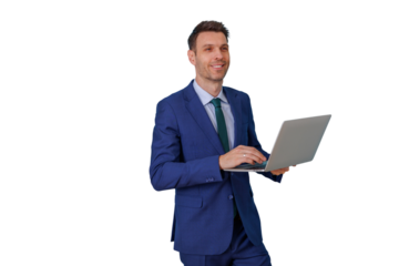 Businessman in a blue suit working on a laptop, smiling confidently and looking forward, representing business technology