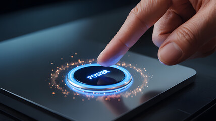 Close up of finger pressing a glowing blue power button on a futuristic metallic panel, technology activation concept