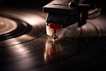 Close-up of record player needle on vinyl with dust particles