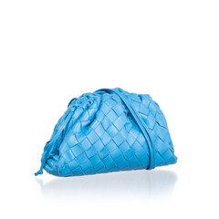 small blue lambskin handbag, photographed on a white background with reflection