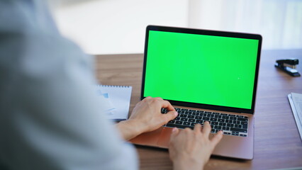 Doctor texting green screen laptop in healthcare facility closeup. Woman typing