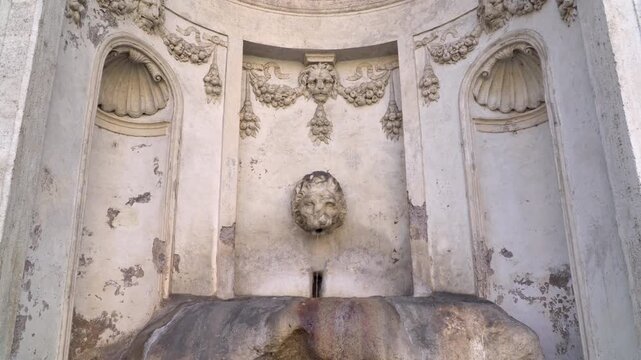The Fountain of the Prisoner, a vintage drinking water fountain located on the slopes of the Janiculum Hill in Rome, Italy.