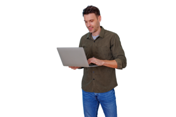 Man standing and working on laptop, typing with a focused smile, embracing remote work and digital innovation