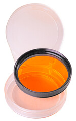 Orange photographic filter in plastic packaging. White background.
