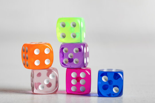 Colorful game dices on white wooden background