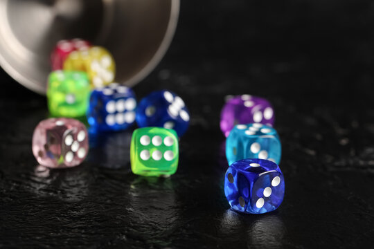 Colorful game dices on black background, closeup