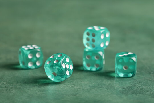 Turquoise game dices on green background