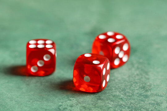 Red game dices on green background