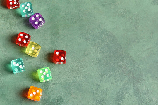 Colorful game dices on green background