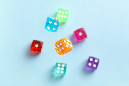 Flying colorful game dices on blue background