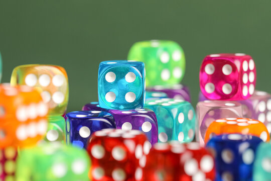 Colorful game dices on green background, closeup