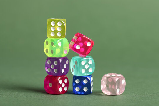 Colorful game dices on green background