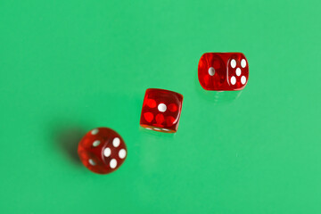 Flying red game dices on green background