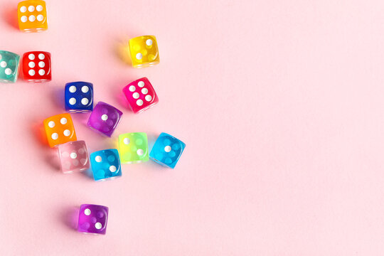 Colorful game dices on pink background