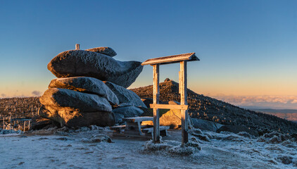Golden Winter Sunset View of Szrenica Peak and Mountain Hut through Wooden Frame, Giant Mountains. 