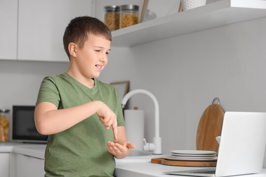 Mute boy using sign language during video call at home