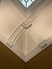 Ornate vaulted ceiling with decorative plaster in white interior