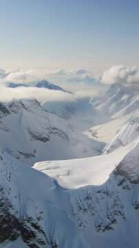 Breathtaking view of the snowy Rocky Mountains and valley on sunny day