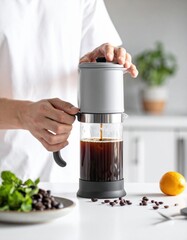 Person Making Cold Brew Coffee With A Pour Over Dripper And Glass Carafe On A White Countertop With Fresh Mint And Lemon