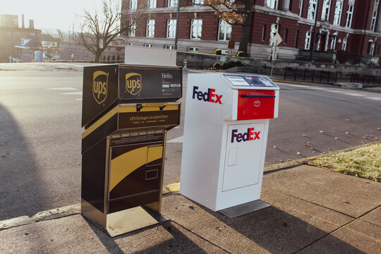 Jefferson City, MO - Dec 25, 2025: Close-up of a FedEx and UPS drop off box on a sunny winter day. For Editorial Use Only.
