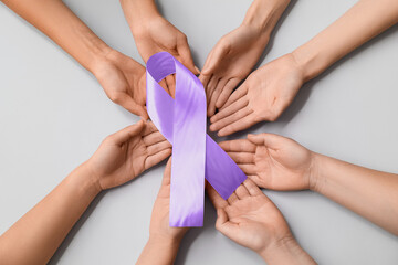Many female hands with pink ribbon on grey background. Breast cancer awareness concept