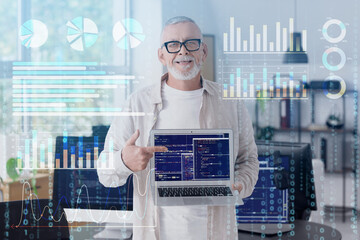 Mature programmer with laptop in office