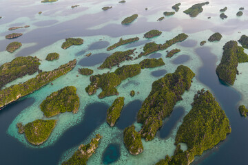 Rugged rock islands, composed of ancient, uplifted reefs, rise from the seascape in Misool, Indonesia. This region harbors spectacular marine biological diversity and is a popular destination for dive