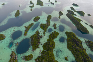 Rugged rock islands, composed of ancient, uplifted reefs, rise from the seascape in Misool, Indonesia. This region harbors spectacular marine biological diversity and is a popular destination for dive