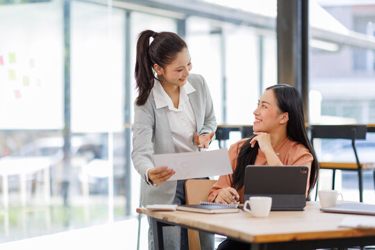 Business women and graphs on tablet screen for finance results, profit growth and budget review. Staff, team and digital with financial report, revenue stats and dividend comparison of risk assessment - Powered by Adobe