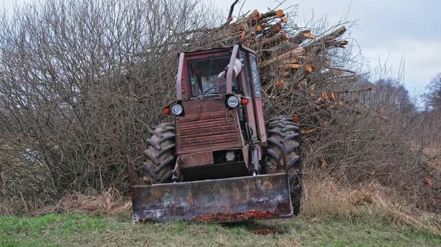 Old Heavy Duty Forestry Landscaping Bulldozer Tractor with Rusted Chassis and Mud Tread Tires