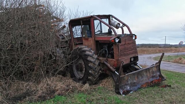 Old Heavy Duty Forestry Landscaping Bulldozer Tractor with Rusted Chassis and Mud Tread Tires
