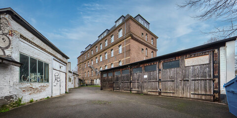 Historic industrial courtyard of the former Helios works in Cologne, Germany. Featuring the Helios Building, old garages, and urban vibes