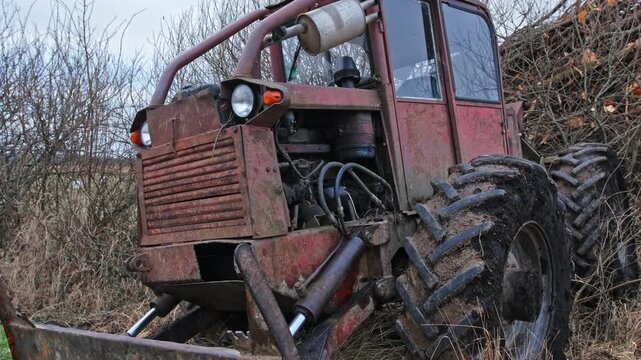 Old Heavy Duty Forestry Landscaping Bulldozer Tractor with Rusted Chassis and Mud Tread Tires