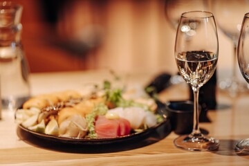 glass of dry White wine ripe grapes and bread on table in vineyard