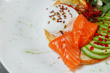 Summer healthy fastfood lunch, breakfast with Pancake with red fish, avocado and egg for breakfast. Aesthetic still life, healthy food concept