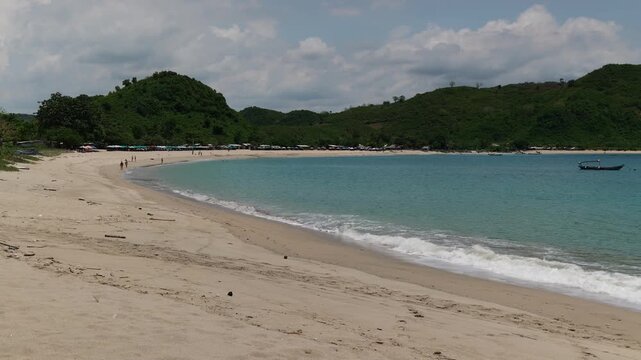 Lombok Indonesia 22 11 2025. Panoramic video of lush green vegetation, blue sea, and white sand beach forming a tropical paradise