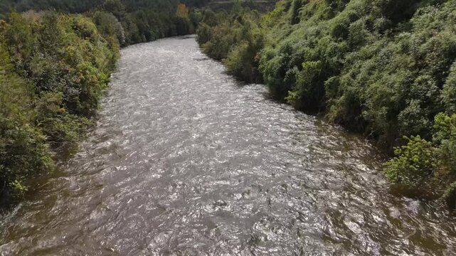 Aerial Fast Upstream Flight Over River with Mountain Horizon Reveal