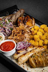 Delicious grilled meat platter with various sauces served on a wooden board, perfect for sharing with friends and family