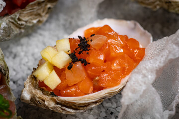 Healthy food. Seafood and toast in a frying pan on a wooden board on a black background.