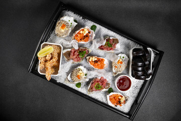 Healthy food. Seafood and toast in a frying pan on a wooden board on a black background.