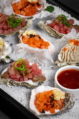 Healthy food. Seafood and toast in a frying pan on a wooden board on a black background.
