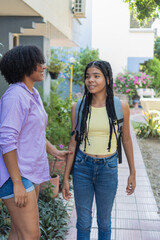 Mother supporting daughter starting school day